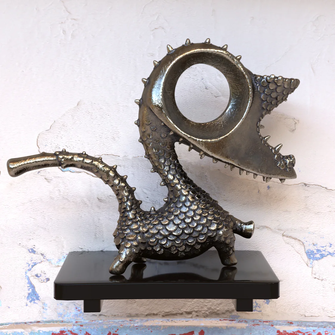 A dark gold dragon sculpture with a circular eye and scaled body.