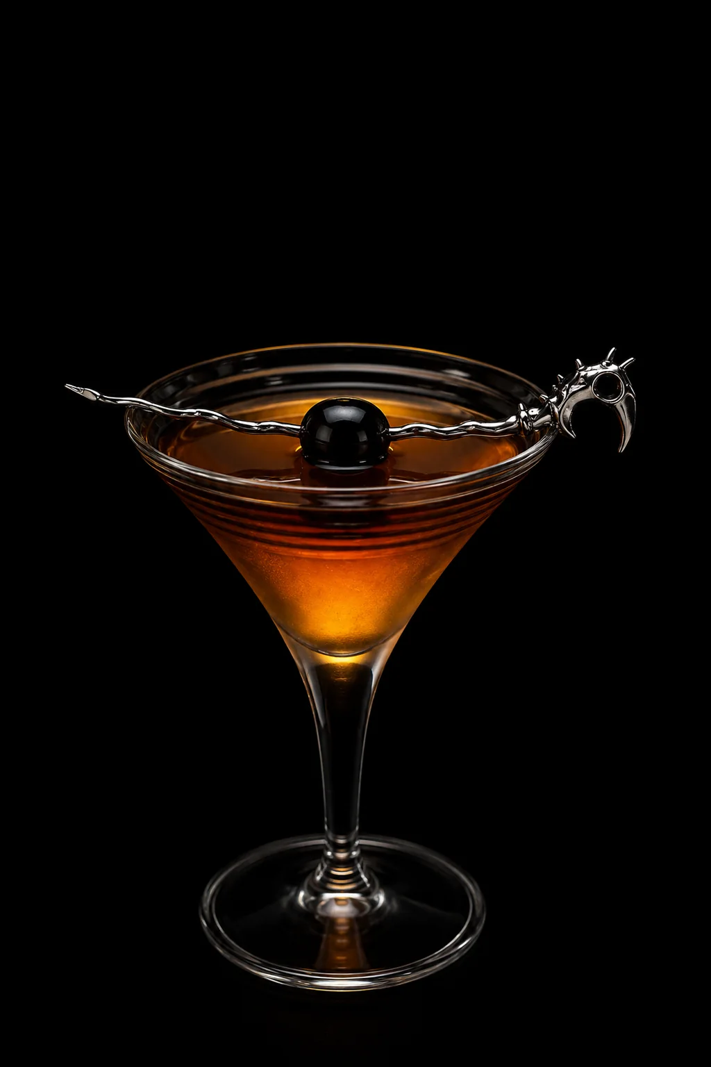A polished Dragon Pick spanning a cocktail against black.