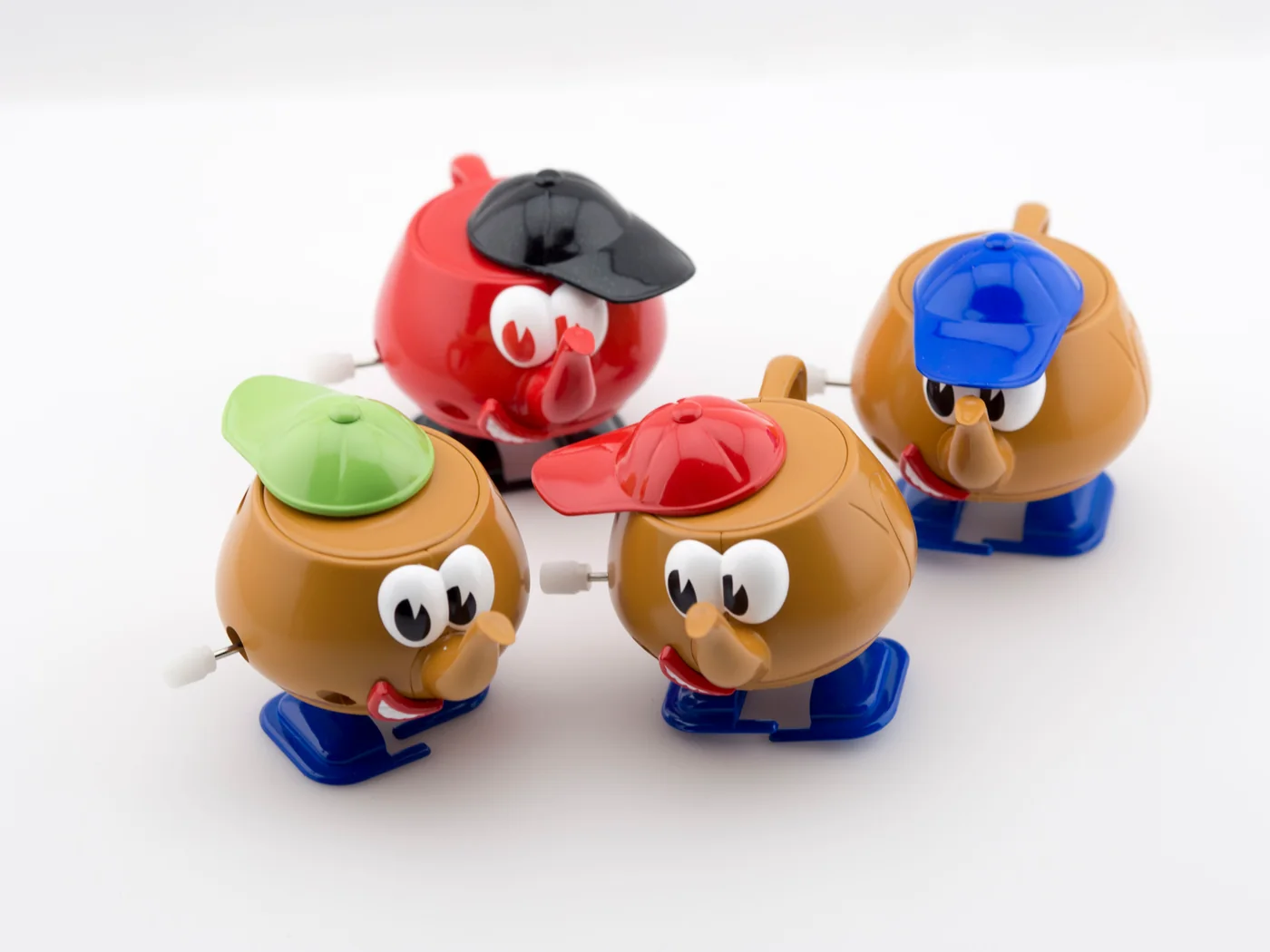 Hot Potato Walking Teapot editions photographed on a pale studio background.