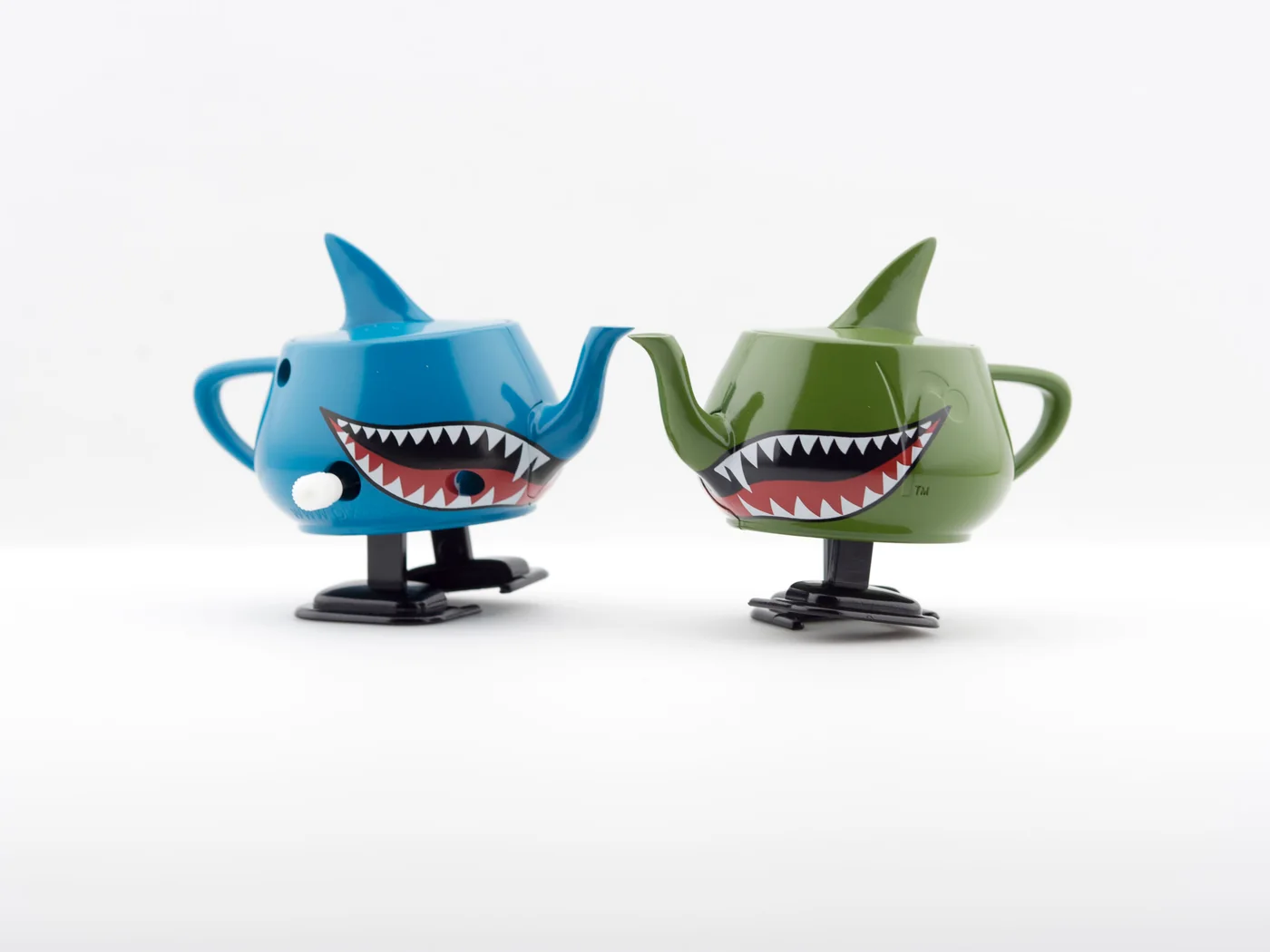 Landshark Walking Teapot editions photographed on a pale studio background.