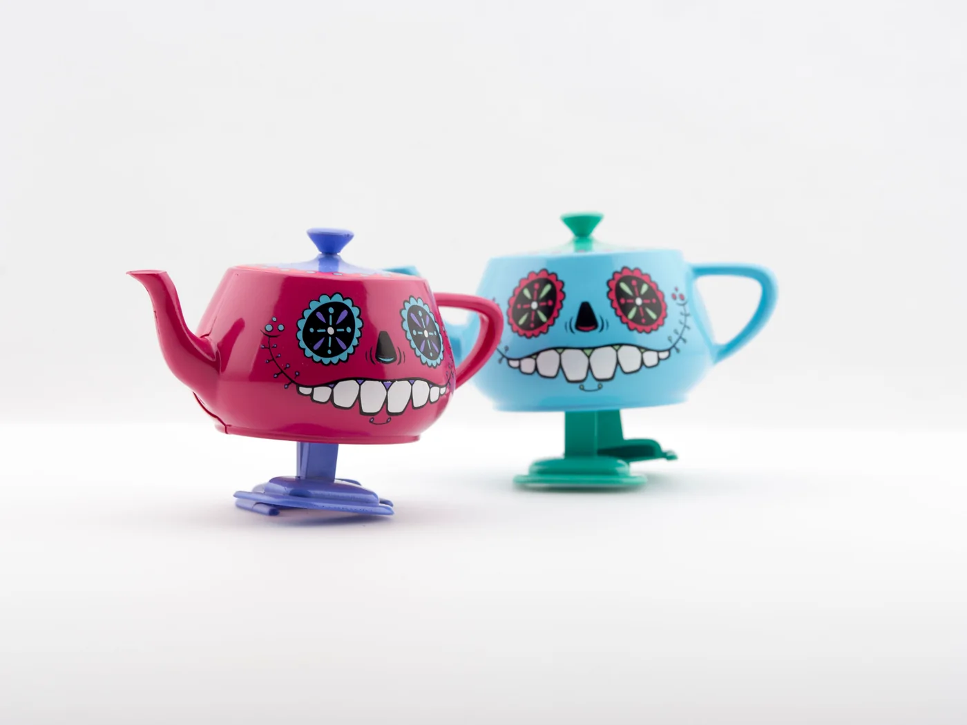 Día de los Muertos Walking Teapot editions photographed on a pale studio background.